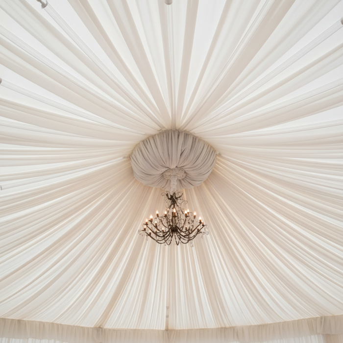 Tent ceiling with radial draping and chandelier drape tube