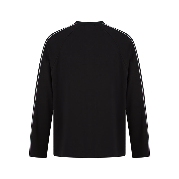 Black long-sleeve raglan top with contrast piping, back view