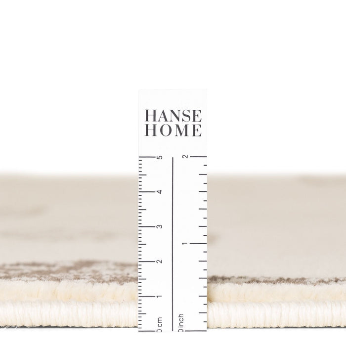Textured fabric swatch with a ruler for measurement and 'HANSE HOME' branding.