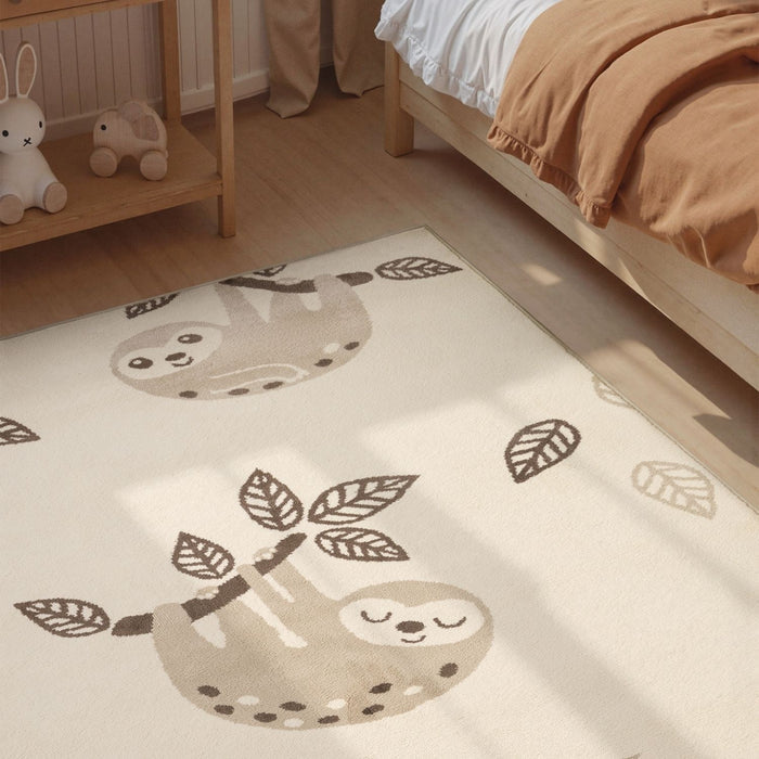 Children's room with a sloth-themed rug on the floor.