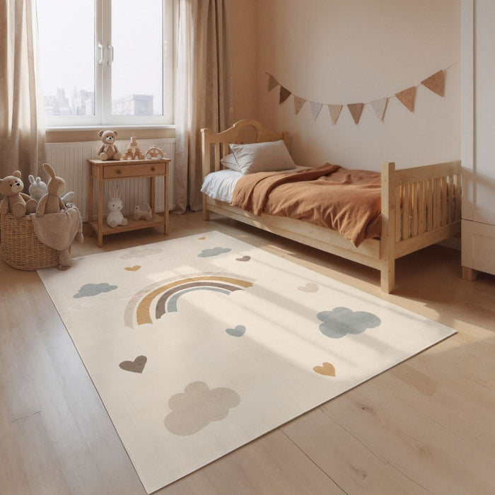 Children's room with a bed, toys, and a rug with rainbow and cloud design.