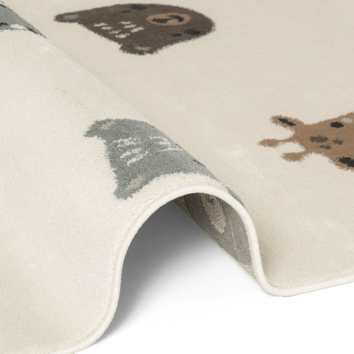 Close-up of a children's rug with bear illustrations on a white background