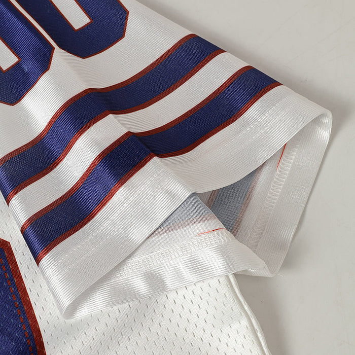 Close-up of a white retro football jersey sleeve with navy and red striped trim and breathable mesh fabric