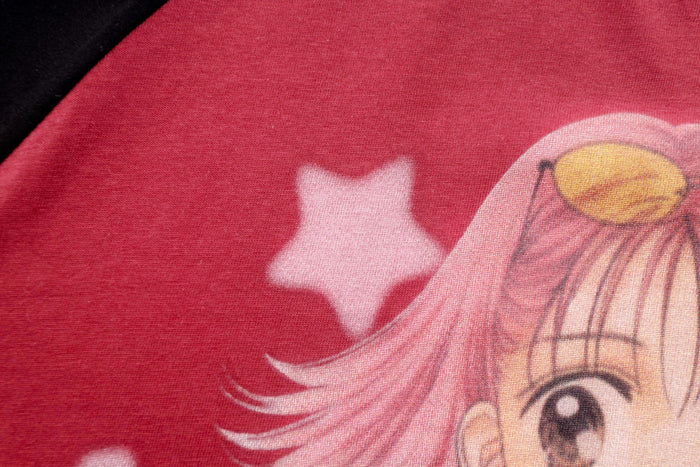 Close-up of pink anime character hair and star on red shirt print