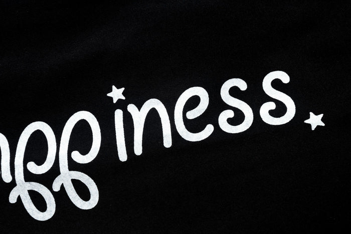 Black sleeve close-up with white 'princess' lettering and small stars