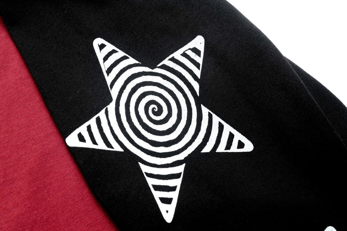 Black sleeve close-up showing white spiral star graphic