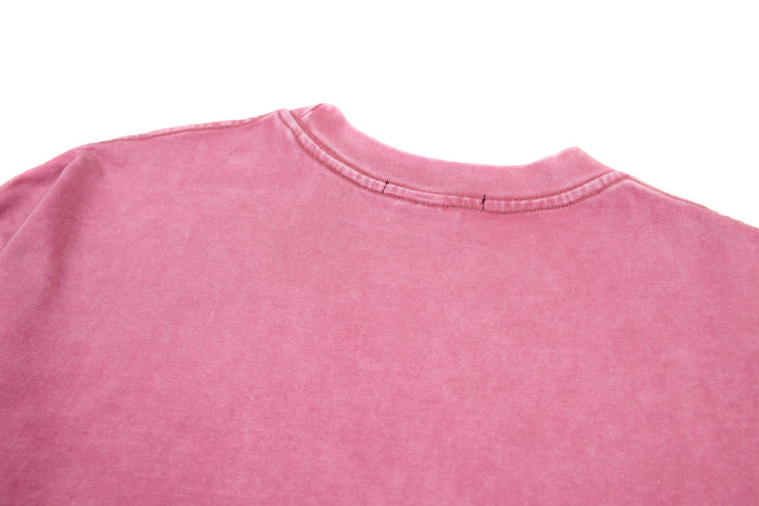 Close-up of pink tee back neckline with ribbed crew neck and stitched seam