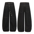 Front and back view of black wide-leg balloon denim pants with diagonal button fly and contrast amber stitching
