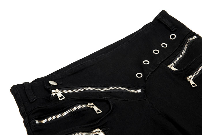 Close-up of black waistband with diagonal zipper and silver grommets