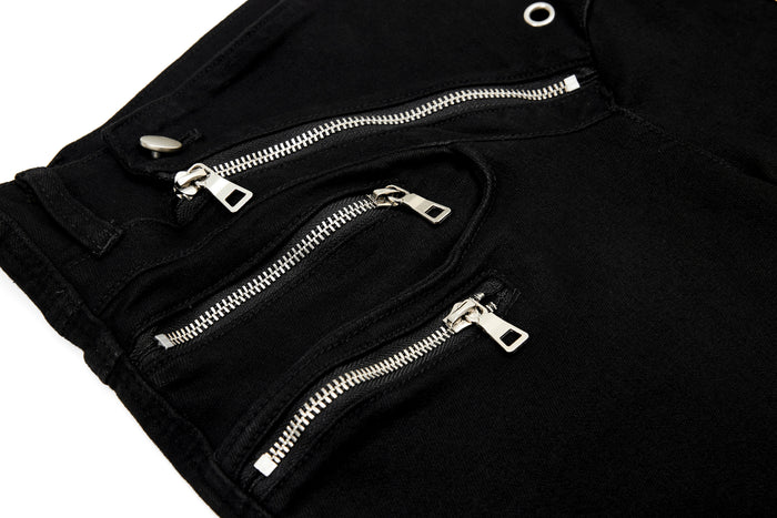 Close-up of layered front zippers on black pants waistband