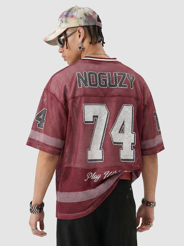 Maroon mesh jersey T-shirt with number 74 and NOGUZY lettering, styled on model with retro varsity streetwear look