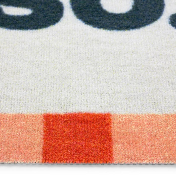 Close-up of a textured surface with a red square and blurred text in the background