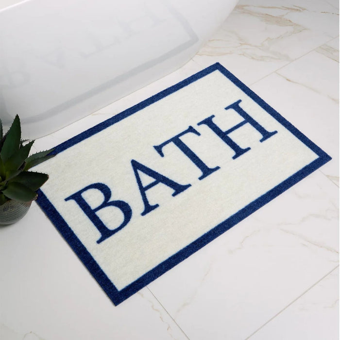 Bath mat with 'BATH' text on a bathroom floor