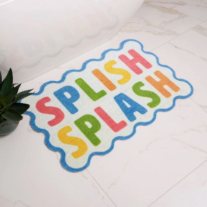 Colorful bath mat with 'Splish Splash' text on a tiled floor.