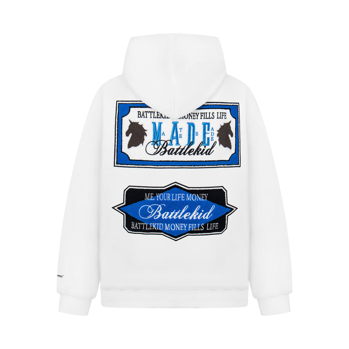 White hoodie back view with large blue and black embroidered MADE badge graphic