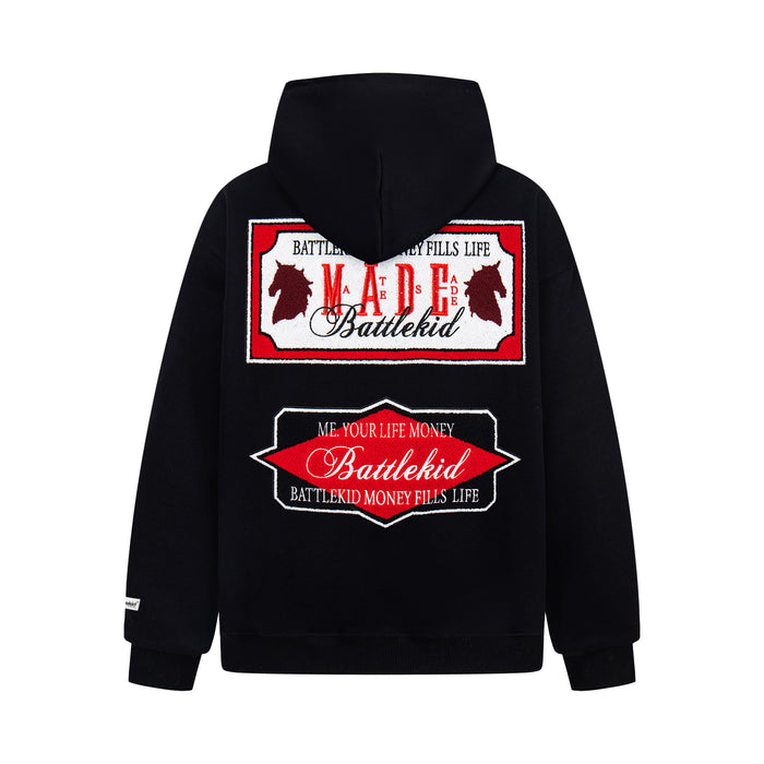 Black hoodie back view with large red and black embroidered MADE badge graphic