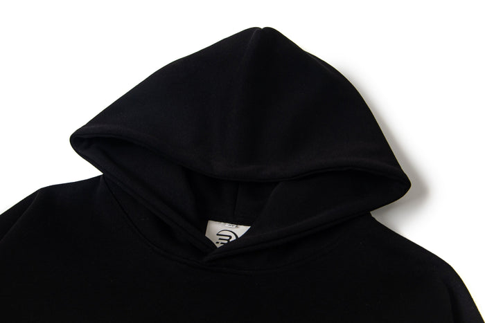 Black hoodie hood close-up showing smooth fabric and inner lining