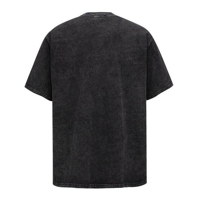 Washed black oversized graphic tee with a faded vintage finish and relaxed streetwear fit