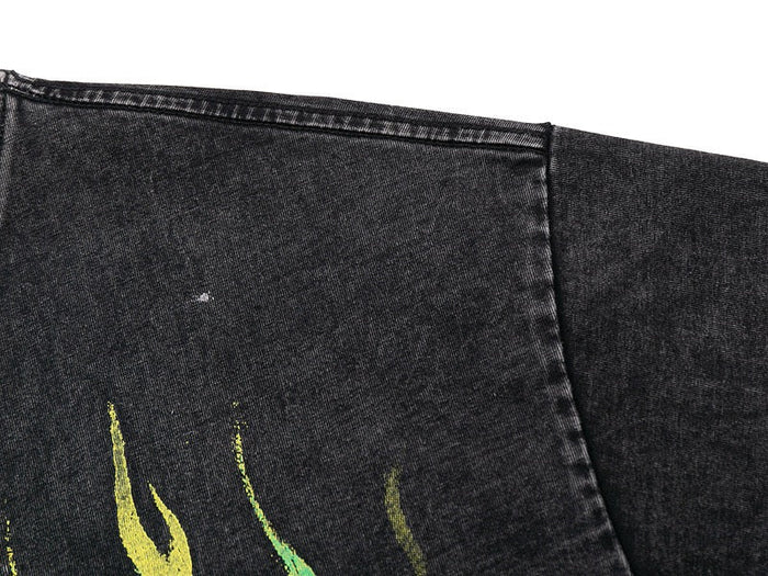 Washed black graphic tee with neon flame print and raw stitched hem in streetwear style