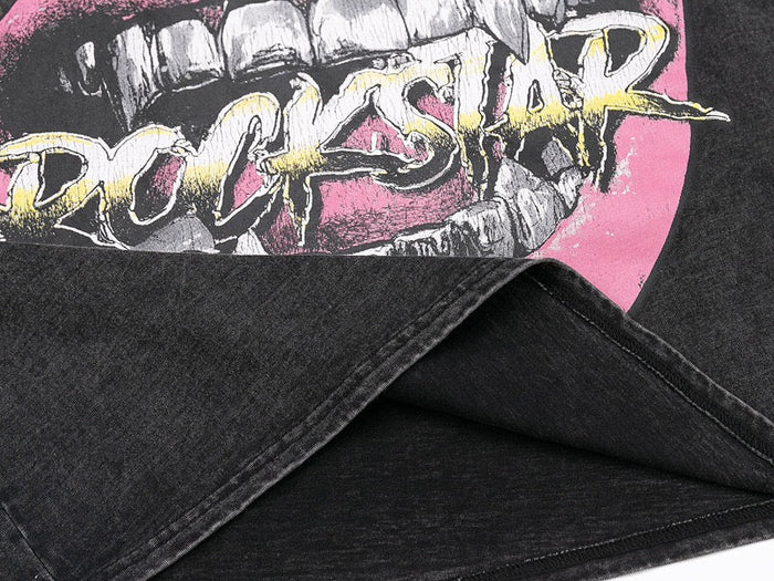 Washed black graphic tee with a pink rockstar flame mouth print and distressed streetwear style