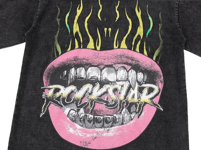 Washed black graphic tee with pink flaming mouth print and bold Rockstar logo