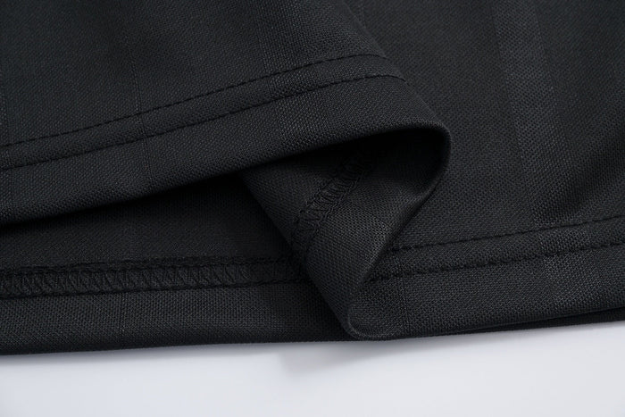 Black mesh athletic tee with triple-stitched hem and folded sleeve detail on a clean white background