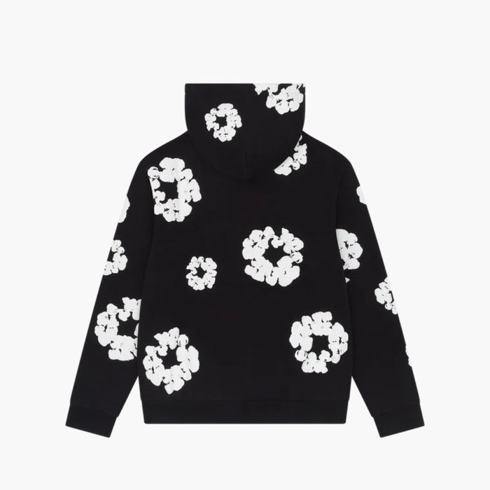 The Black “Cotton Wreath” Denim Tears Hoodie features a white floral ring print, blending bold streetwear design with comfort.