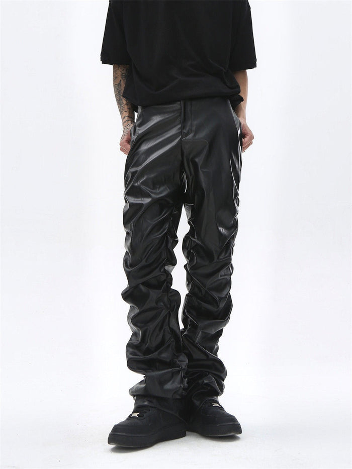 Black faux leather straight-leg pants worn front view, showing heavy ruched legs and cuffs