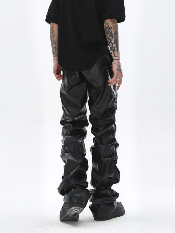 Black faux leather straight-leg pants worn back view, with ruched legs and patch pockets