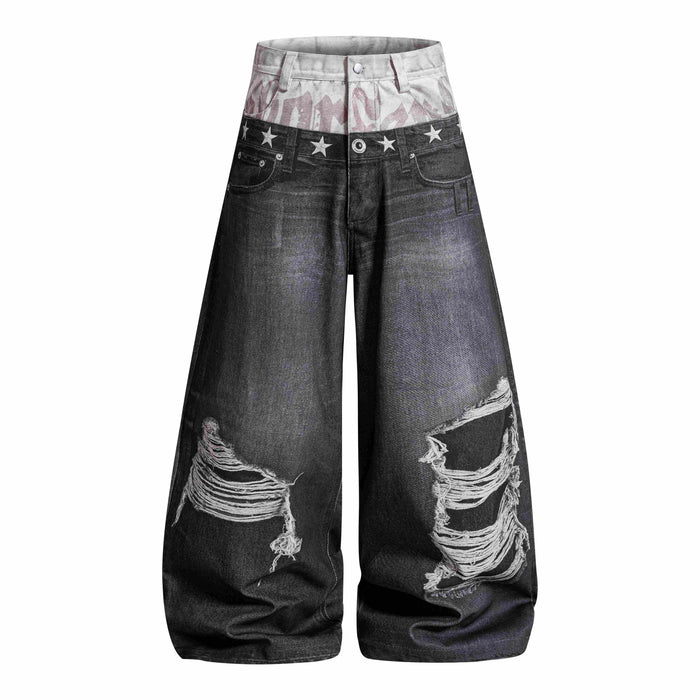 Front view of black layered balloon jeans with distressed knees and star-print waistband