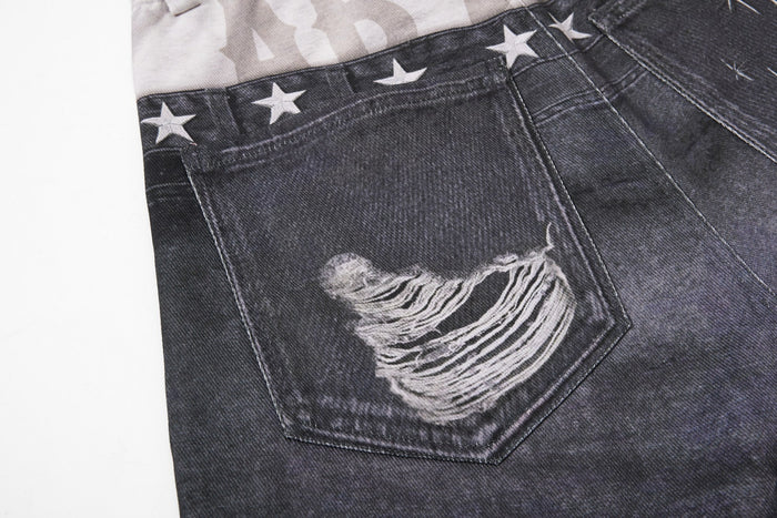 Close-up of back pocket on black denim with large distressed patch and star trim