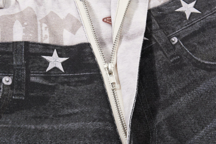 Close-up of front zipper area on layered jeans with star print fabric