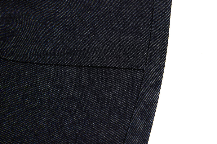 Close-up of black denim hem with clean straight stitching