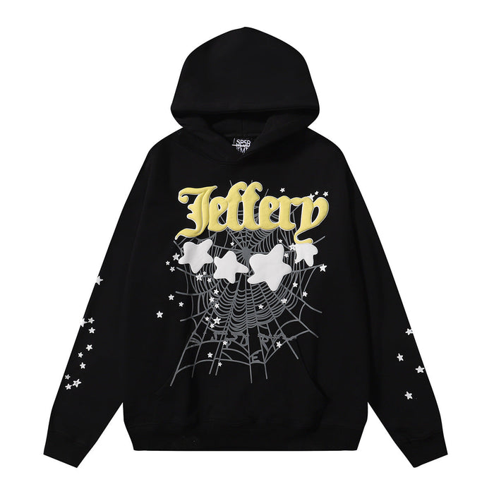 The Sp5der Jeffery Hoodie – Black Web 440GSM Heavyweight Streetwear Pullover features bold yellow “Jeffery” lettering, a front white spider web with stars and shapes, and trendy star patterns on both sleeves.