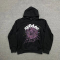 The Black Sp5der Web Hoodie 440GSM features a bold purple web and white stars on the front, "sp5der" in striking white lettering above, making this black spider hoodie a standout choice for streetwear style.