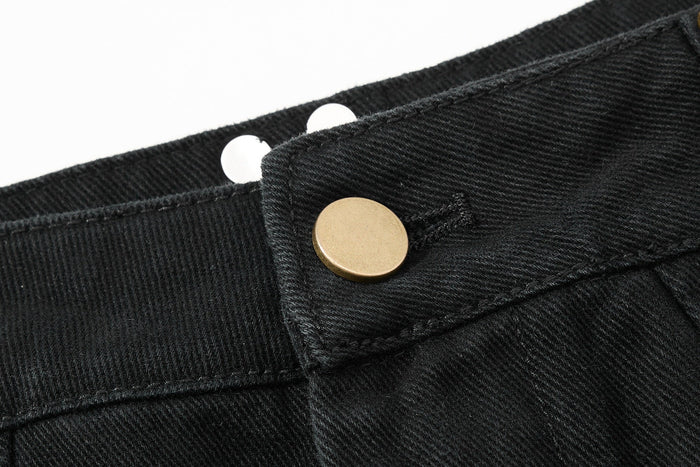 Close-up of black pants waistband snap button and textured twill fabric