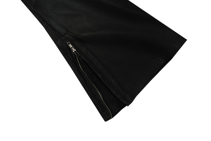 Close-up of black pant leg hem with side zipper opening