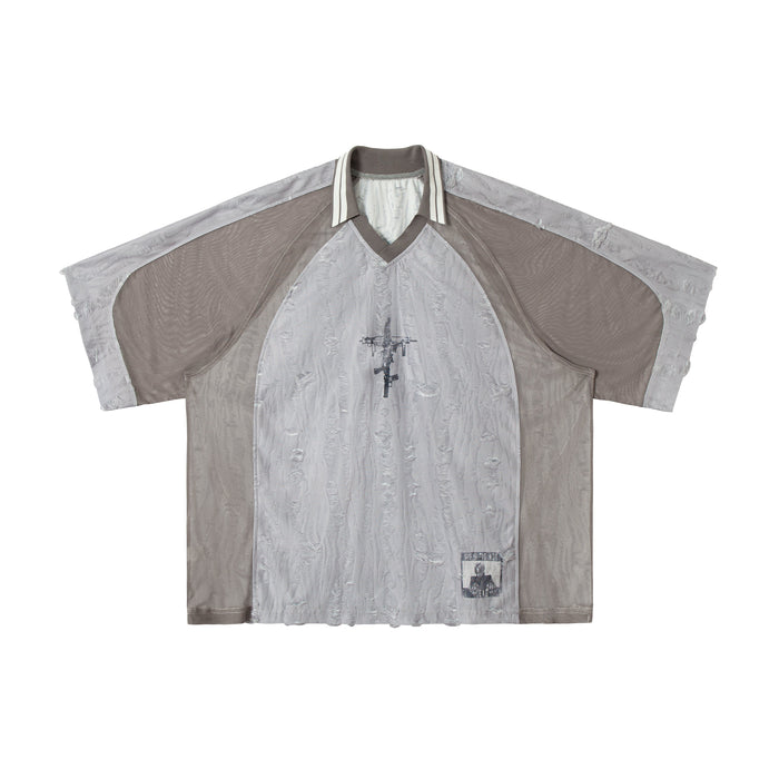 Gray patchwork mesh tee with distressed texture, striped collar, and graphic print on the chest