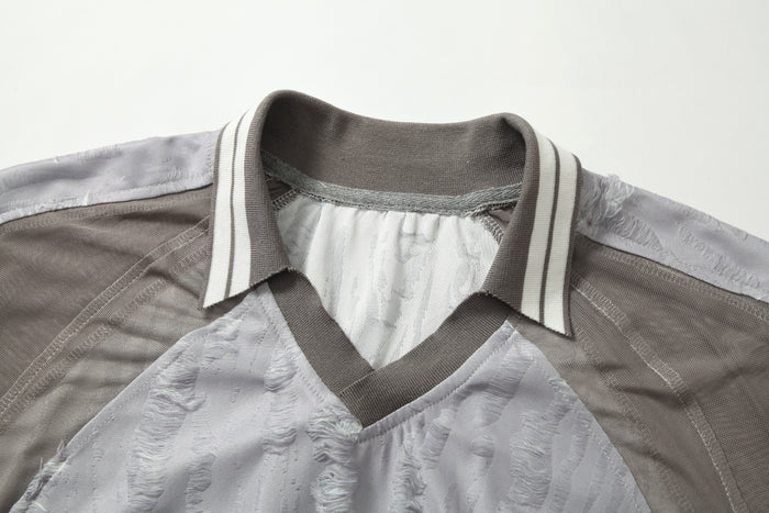 Textured patchwork tee with striped collar and distressed mesh panels in gray and white