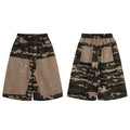 Front view of oversized camo patchwork baggy shorts with khaki contrast panels and white paint splatter detailing