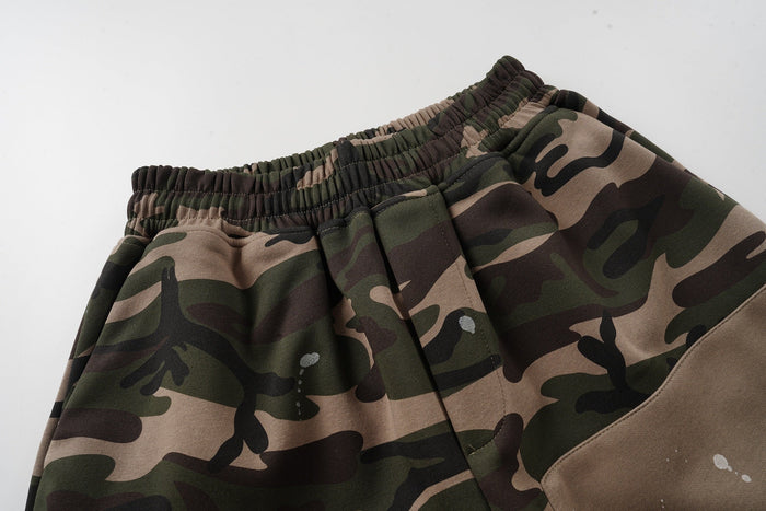 Close-up of the elastic waistband and camo patchwork fabric on baggy shorts
