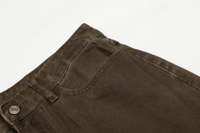 Close-up of back waistband and yoke seam on brown washed cotton pants