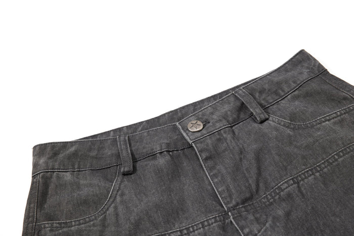 Close-up of dark gray pants waistband with star button and belt loops