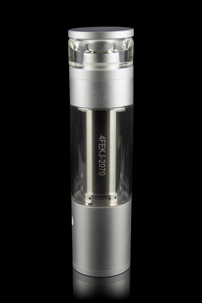 Silver cannabis oil vape pen with a glass mouthpiece and engraved serial number, isolated on black.