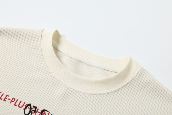 Close-up of cream ribbed crew neck on long sleeve tee