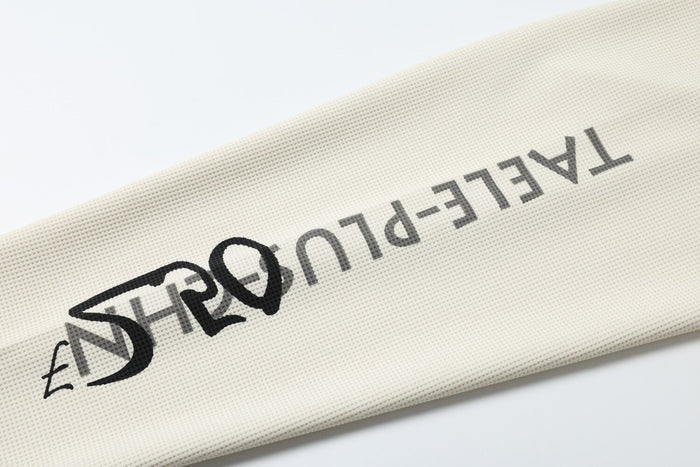 Printed text detail on cream sleeve with black and gray lettering