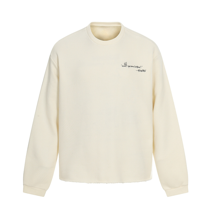 Front view of cream sweatshirt with small black chest text and long sleeves