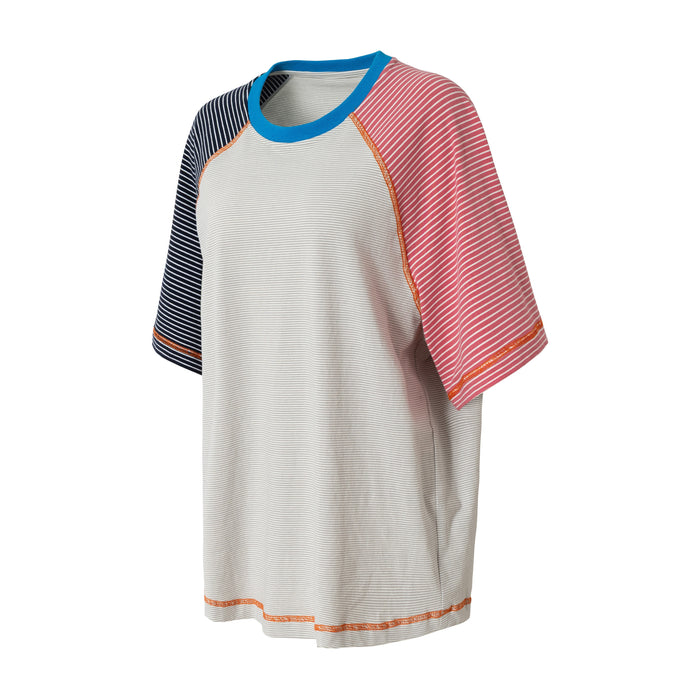 Color block raglan T-shirt with blue neckline, striped navy and pink sleeves, and relaxed fit on white background