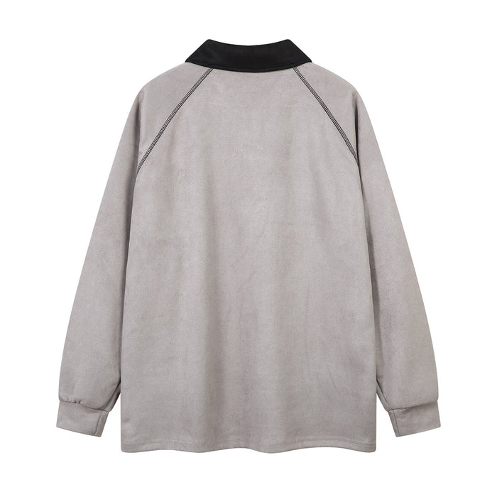 Back view of light gray long-sleeve polo shirt with black collar and contrast shoulder seams