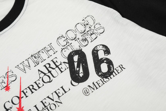 Close-up of front graphic on white raglan tee showing black text, red accents, and large 06 print